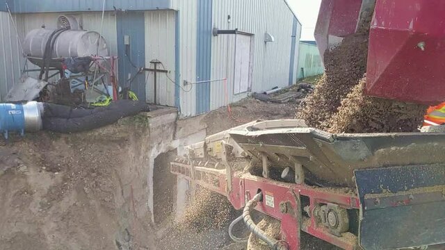 SLO MO Gravel being unloaded from a piece of specialized equipment at the construction site.  Stone slinger thrower. 4k
