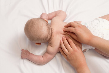 baby massage, close-up hands on baby back