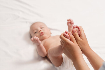 baby foot massage, close-up of hands and foot of baby