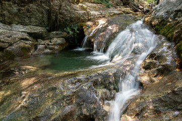 Fototapeta na wymiar waterfall in the forest, rocky river, waterfall in the mountains, Mountain stream