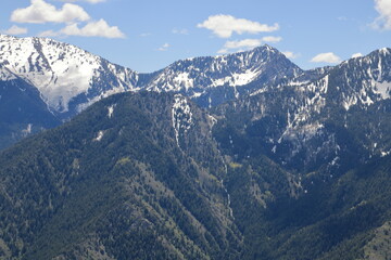 Fototapeta na wymiar Tall snowcapped peaks of the Wasatch mountains in late May, Salt Lake City, Utah