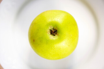  green apple on a white plate