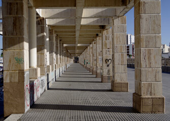 The symmetry of a long colonnade with light and shadow.