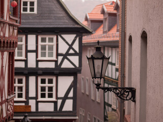 Street with houses and lantern in old town of Marburg, Germany in autumn