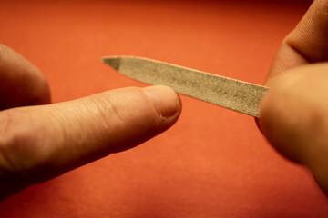we process the nails on the hands with a nail file.