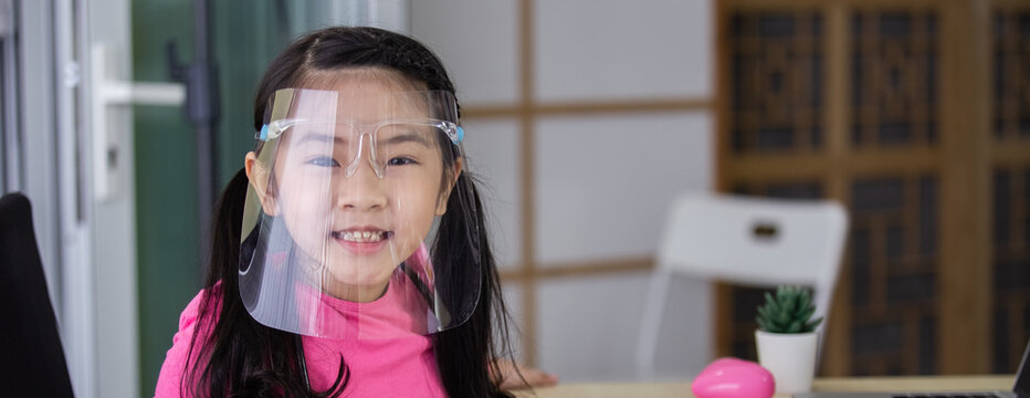 Asian Girl Kid Wearing Face Shield Protect Against Airborne Disease For Prevent Infection Coronavirus Covid 19.