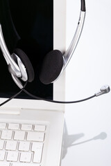 headset keyboard notebook laptop in office on table desk