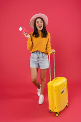 Happy young female walking with the travel bag