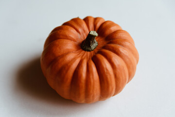 Orange pumpkin on a whtie background. Halloween concept