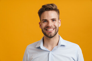 Photo of joyful unshaven man smiling and looking at camera
