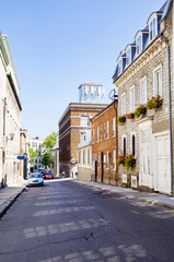 Romantic side street or alley in historic old town of Quebec City, Canada with French Canadian...