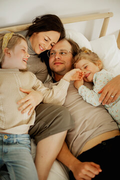 Family lying in bed