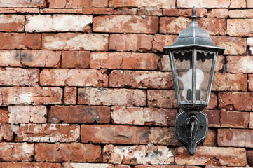 lantern on a brick background. old lamp on the wall. lamp on decorative surface