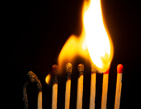 Group of red match burning isolated on black background.