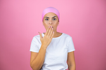 Young beautiful woman wearing pink headscarf over isolated pink background surprised covering her mouth
