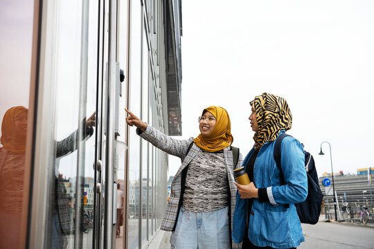 Female friends standing in front of building