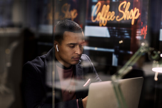 Man using laptop in cafe