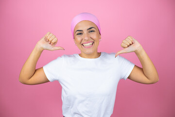 Young beautiful woman wearing pink headscarf over isolated pink background looking confident with...