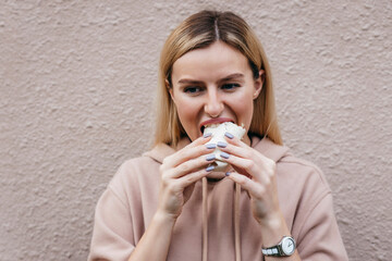 Portrait of young girl eating chicken roll on street