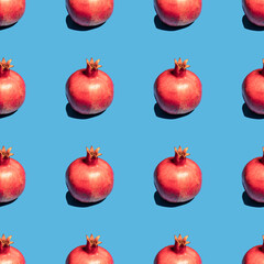 Seamless pattern with pomegranate fruit for Jewish holiday Rosh Hashanah on blue background.