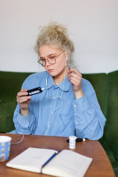 Young woman using glucometer