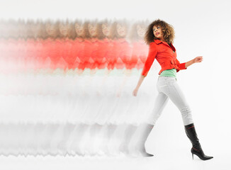 Multiple exposure shot of a young afro woman with curly hair walking against white background