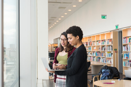 Women in library using laptop