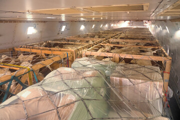 Livestock in wooden boxes secured by nettings being shipped on the main deck cargo hold of a Jumbo Jet freighter aircraft
