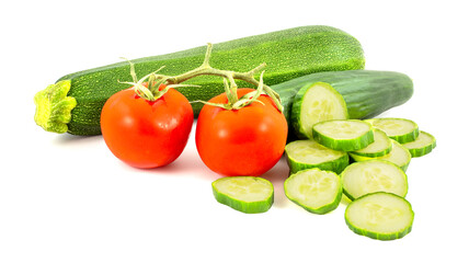 Sliced green cucumber, 2 red tomatos and green zucchine isolated on a white background.
