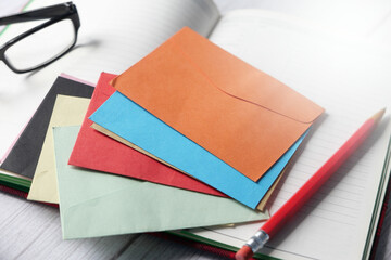 colorful envelopes and notepad on table 