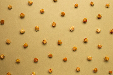 Dry globe amaranth flowers on brown kraft paper. floral pattern background