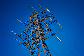 High voltage electrical support on blue sky background.