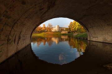 Fototapeta na wymiar An ancient palace and park in the city of Gatchina. Landscape morning golden autumn, .view across the bridge
