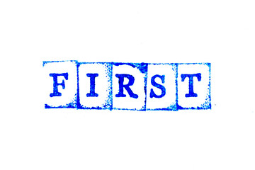 Blue color ink of rubber stamp in word first on white paper background