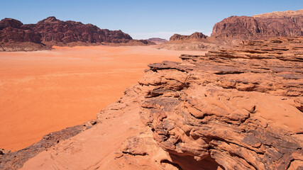 Sandy rocks in the hot desert of Wadi Rum in Jordan by day