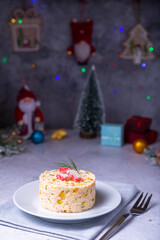 Crab salad with corn and eggs on a white plate. New Year's and Christmas. Traditional Russian salad. Close-up.