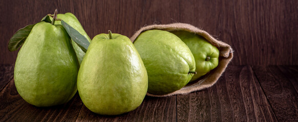 Close up of delicious guava with fresh green leaves.
