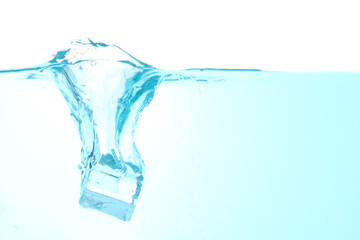 Throw ice into the water making a clear blue splash water wave, isolated on a white background. with copy space