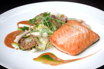 Grilled salmon and lemon - french cuisine dish with tomato and salmon