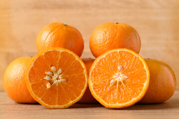 Fresh Honey Murcott orange fruit on wooden background