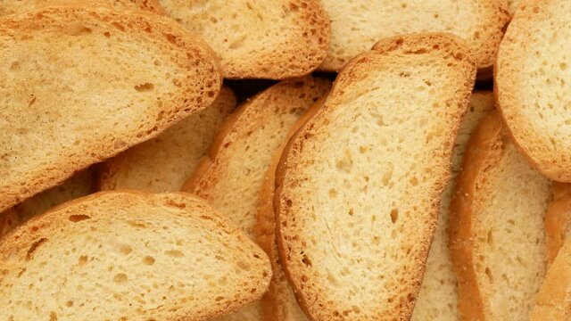 Rusks - background. Dried bread with a golden crust, dolly shot.