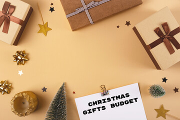 Planning a budget for Christmas gift shopping with brown boxes with ribbons. Top view, flat lay, copy space with mock up
