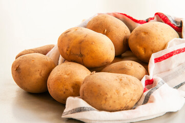 stack of potatoes close up on kitchen table