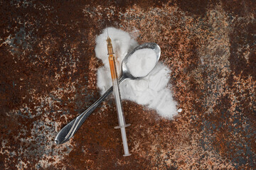 Syringe and drugs on dirty rusty background. Injection syringe. addiction