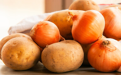 golden onion and potaoes close up on kitchen table
