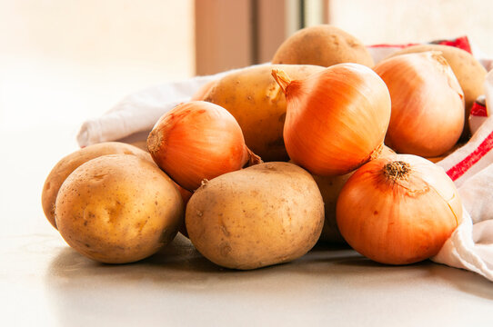 golden onion and potaoes close up on kitchen table