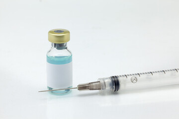 Isolated glass vaccine bottle with colored liquid and syringe very close high magnification mockup