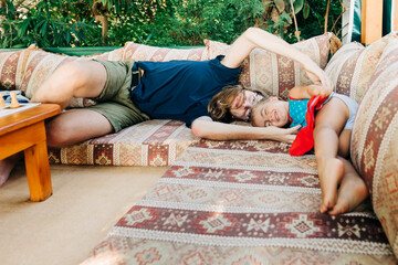 Toddler girl and young man having fun together