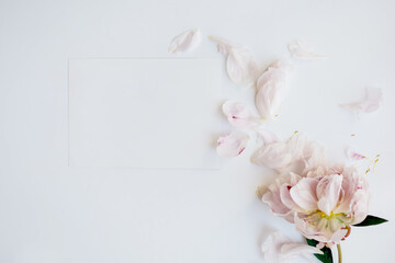 Summer wedding stationery mock-up scene. Blank horizontal greeting card and peony flowers isolated on white table background.