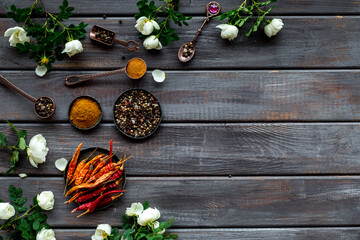 Kitchen utensils with spice and herbs in metal bowls, overhead